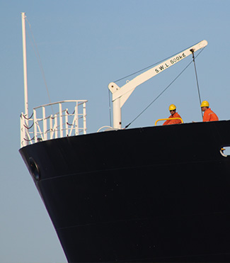 A large black boat equipped with fire safety equipment.