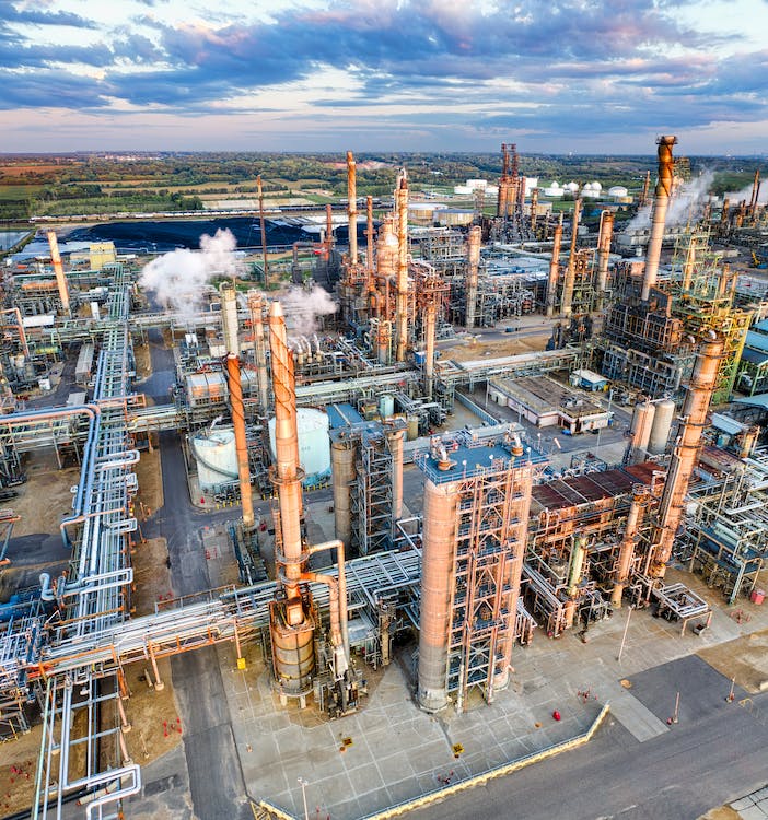 An oil refinery with numerous pipes and fire safety equipment.