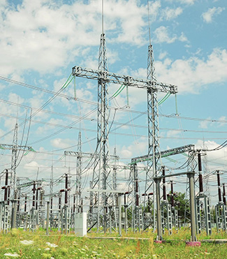 A vast field with numerous electrical towers, surrounded by fire safety equipment.