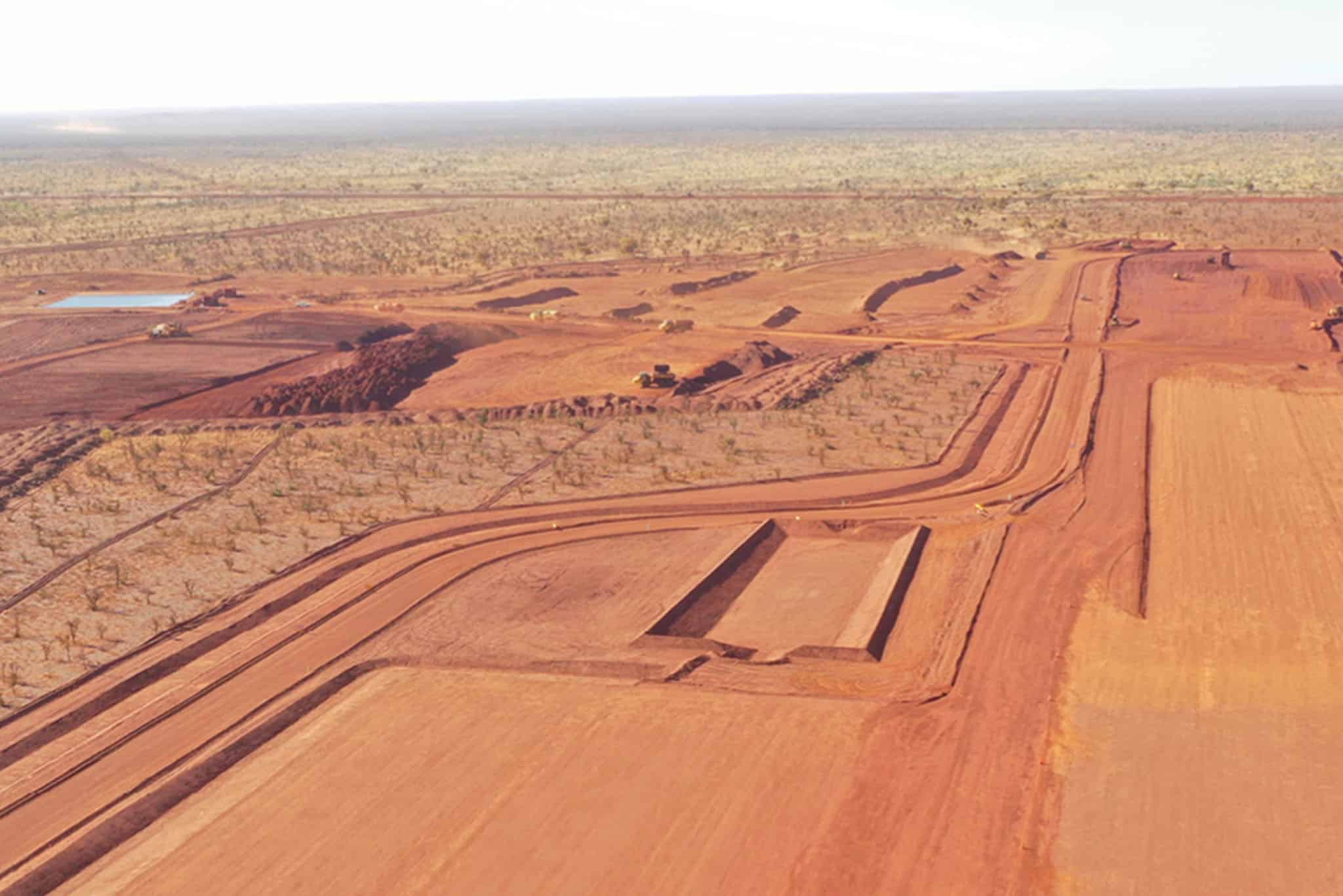 An aerial view of an open pit mine with fire safety equipment in place to ensure worker protection.