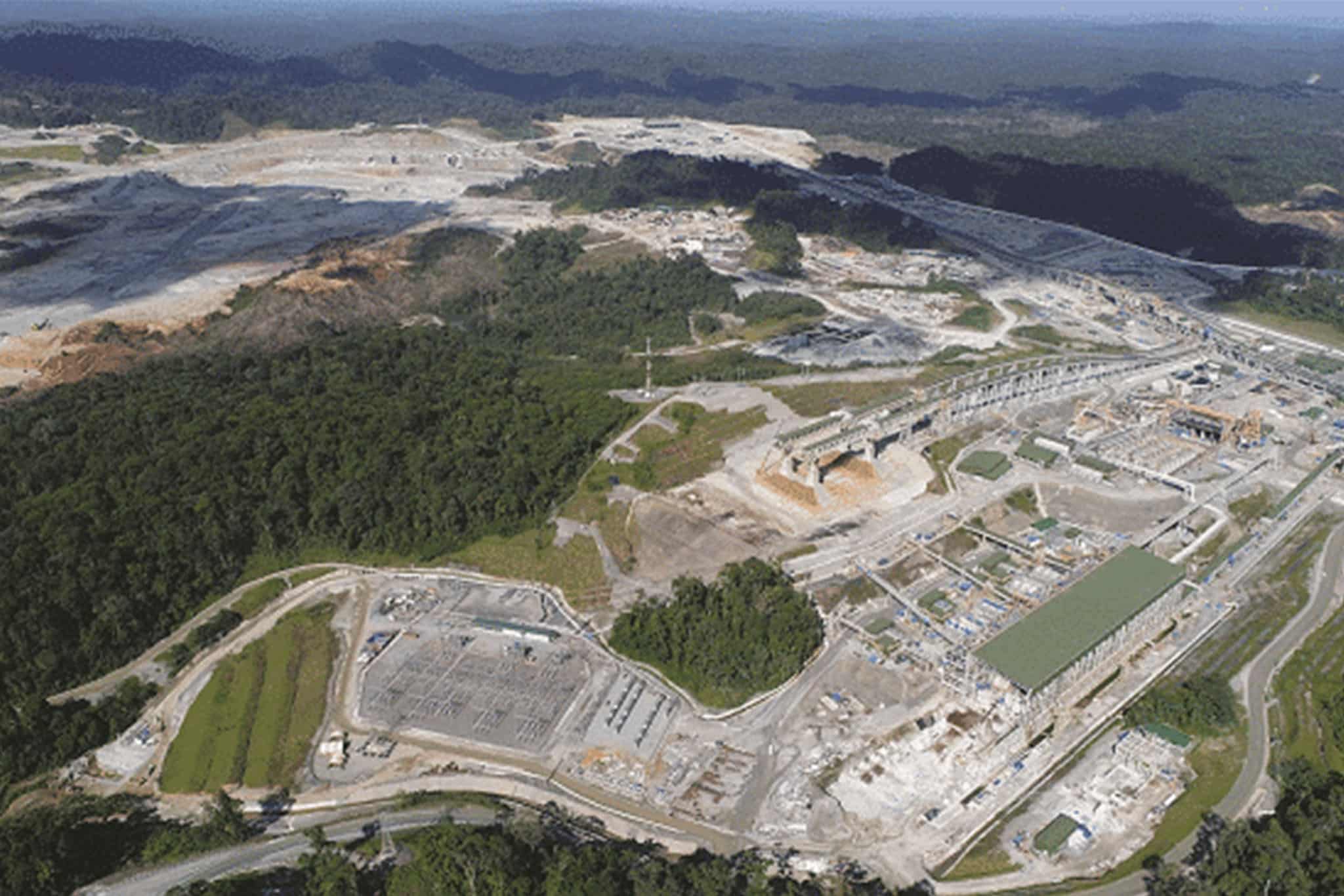 An aerial view of a large quarry construction site, showcasing fire safety equipment in place.