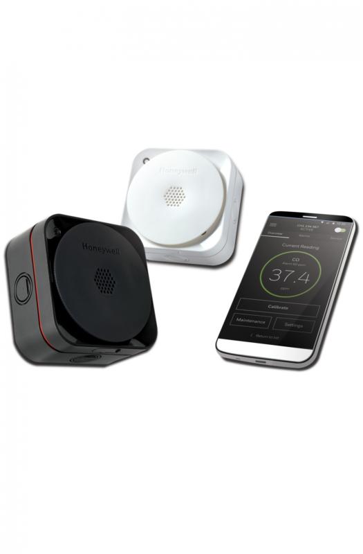 A smartphone positioned alongside a Sensepoint XCL device, showcasing modern technology in close proximity.